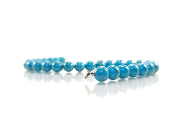 Turquoise necklace on white background