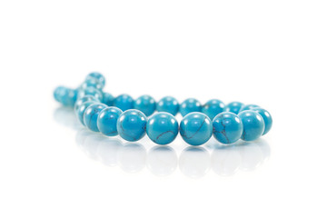 Turquoise necklace on white background