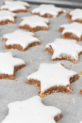 Making self-made christmas star cinnamon cookie, closeup, low focus