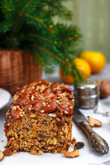 Traditional Christmas fruit cake with nuts, raisins, dried fruits and spices. Christmas treat. Selective focus