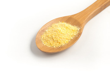 Corn Couscous into a spoon. Cuscus