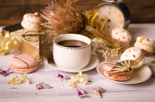 Cup of coffee with macaroons, dried flowers protea - Powered by Adobe