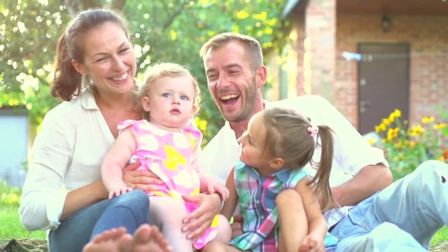 Happy joyful young family with children having fun outdoors. Slow motion 240 fps, Full HD 1080p