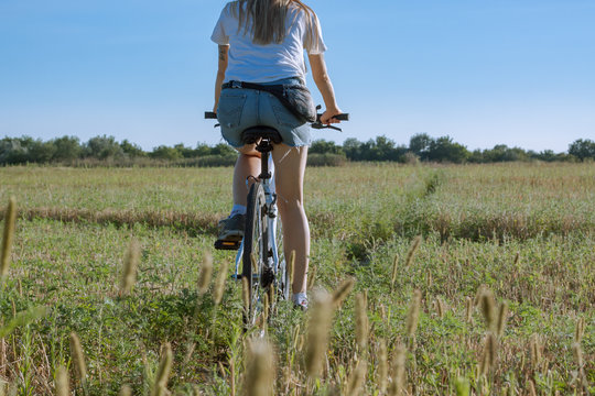 Woman riding on mountain bike back view close up picture