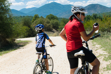 Mother and son mountain biking