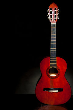 acoustic guitar, stringed instrument / lonely musical instrument which is a guitar on a black background