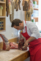 Butcher Preparing Meat In Shop