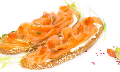 Naklejka na ściany i meble Sandwiches with salmon caviar and greens adorned 