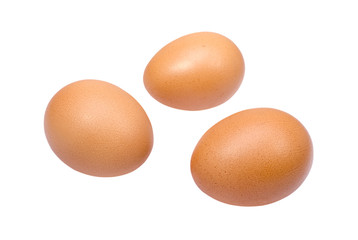 Three brown eggs isolated on white background