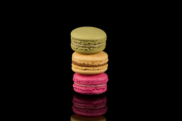 Colorful macaroon over black background