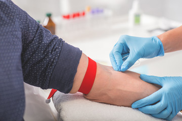 Obraz premium Man having blood collecting in hospital