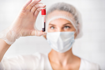 Professional general practitioner analyzing human blood