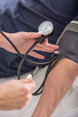 Doctor checking patient pulse in clinic