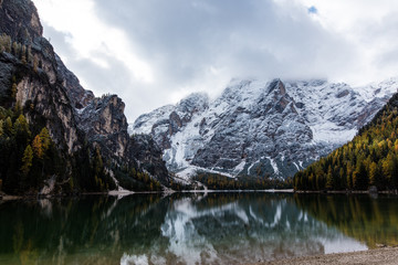 Fototapeta na wymiar Autumn to Winter transmission at Lago di Braies, Italy