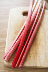 bunch of rhubarb on a wooden board