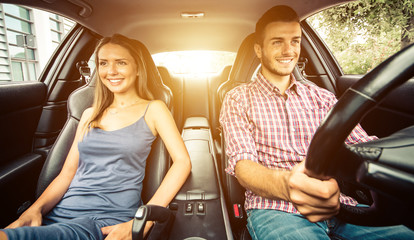 Couple driving in a sport car