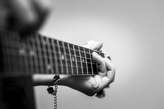 Woman hands and black acoustic guita