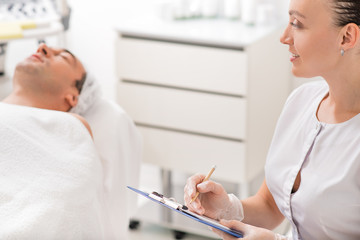 Skillful physician examining patient before therapy