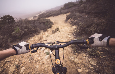 Obraz premium Downhill pov view with mountain bike