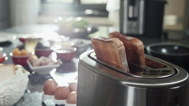 Roasted toast bread popping up from toaster slow motion