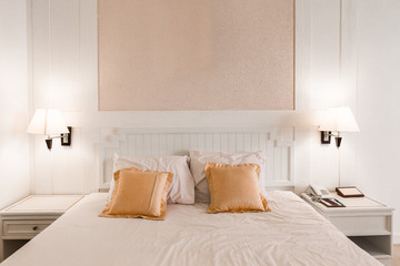 White bedroom with a king size bed and pillows