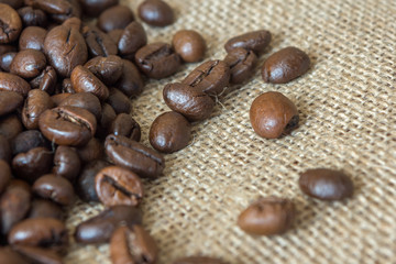 Cup and grain of coffee over textile background
