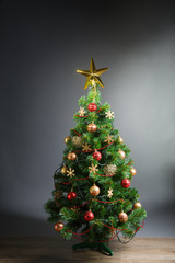 Christmas tree with gold star, grey background
