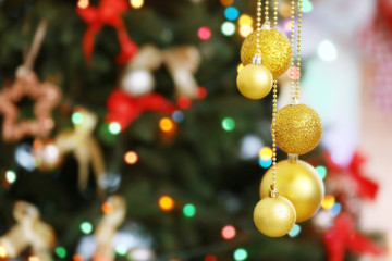 Fototapeta na wymiar Beautiful balls on blurred Christmas tree background, closeup