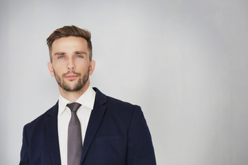 Young businessman on light background