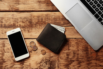 Workplace with stylish leather wallet and smartphone - Powered by Adobe