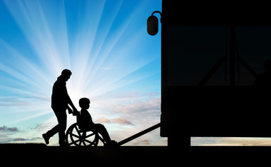 Fototapeta na wymiar Disabled child in a wheelchair dad raises on bus