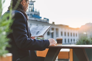 Businessman having coffee break outdoors