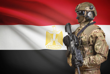Soldier in helmet holding machine gun with flag on background series - Egypt