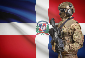 Fototapeta premium Soldier in helmet holding machine gun with flag on background series - Dominican Republic