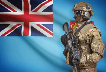 Soldier in helmet holding machine gun with flag on background series - Fiji