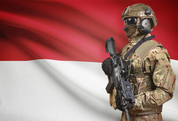 Soldier in helmet holding machine gun with flag on background series - Indonesia - obrazy, fototapety, plakaty