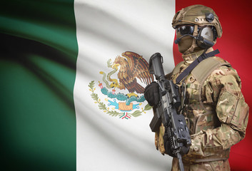 Soldier in helmet holding machine gun with flag on background series - Mexico