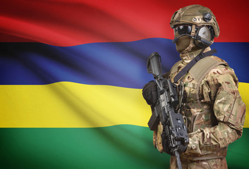Soldier in helmet holding machine gun with flag on background series - Mauritius