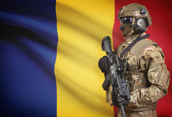 Soldier in helmet holding machine gun with flag on background series - Romania