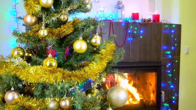 decorated christmas tree with lights in front of fireplace