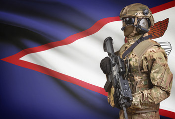Soldier in helmet holding machine gun with flag on background series - American Samoa
