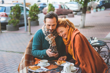 Mature loving couple drinking tea outdoors