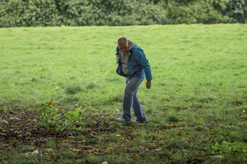 senior man on the walk is looking for something