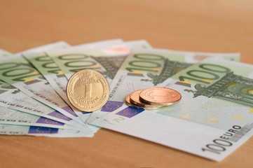Ukrainian coin stands on the background of european euro