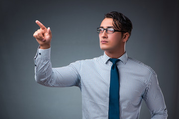 Handsome businessman pressing virtual buttons