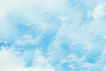 Soap bubbles floating in a blue sky background