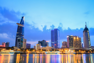 Fototapeta na wymiar Night view of Downtown center of Ho Chi Minh city on Saigon riverbank in twilight, Vietnam. 