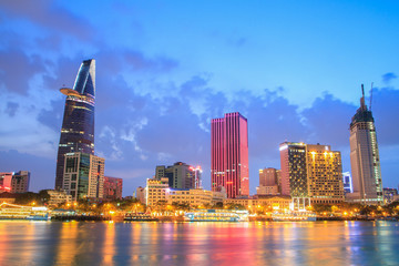 Obraz na płótnie Canvas Night view of Downtown center of Ho Chi Minh city on Saigon riverbank in twilight, Vietnam. 