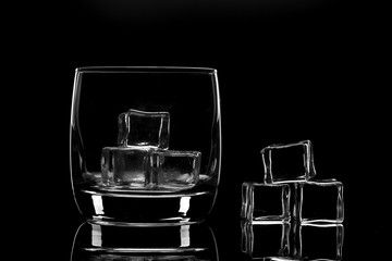 Empty glass filled with ice cubes. Nice reflection From the glass.