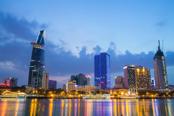 Fototapeta na wymiar Night view of Downtown center of Ho Chi Minh city on Saigon riverbank in twilight, Vietnam. 